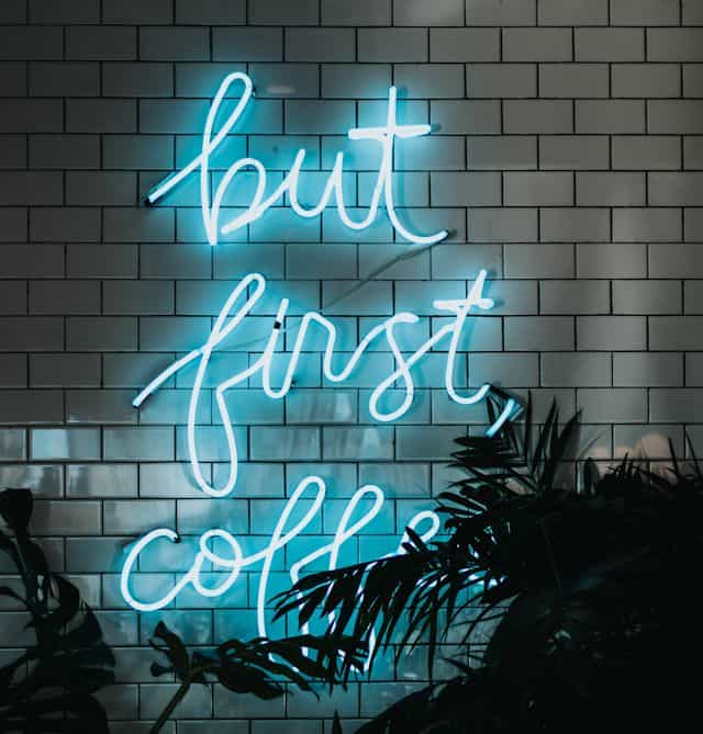 Neon sign with saying But First Coffee -- the first step to meeting with Lawrence Fox, bookkeeper and accountant!